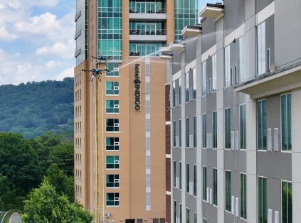 Drone cleaning the Hotel Indigo facade