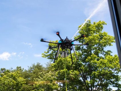 Sherpa drone in flight against trees